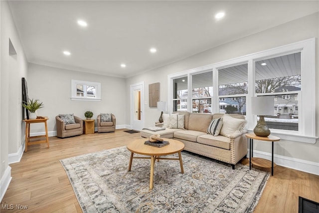 living room featuring baseboards, wood finished floors, and recessed lighting