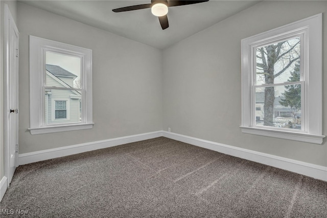 empty room with carpet floors, ceiling fan, and baseboards