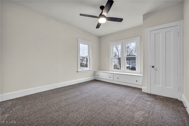 unfurnished bedroom featuring a ceiling fan, carpet flooring, and baseboards