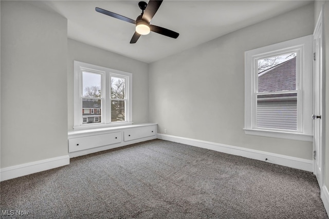 spare room featuring baseboards, carpet floors, and a healthy amount of sunlight