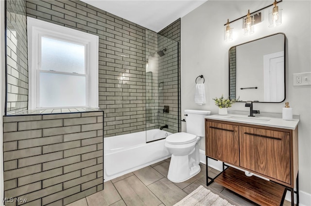 bathroom with washtub / shower combination, vanity, and toilet