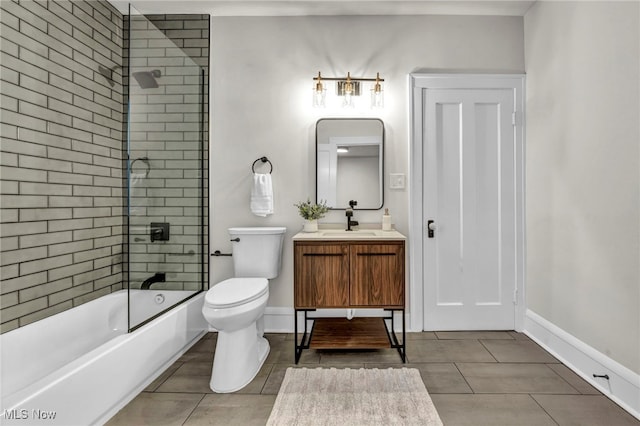 bathroom featuring toilet, baseboards,  shower combination, and vanity