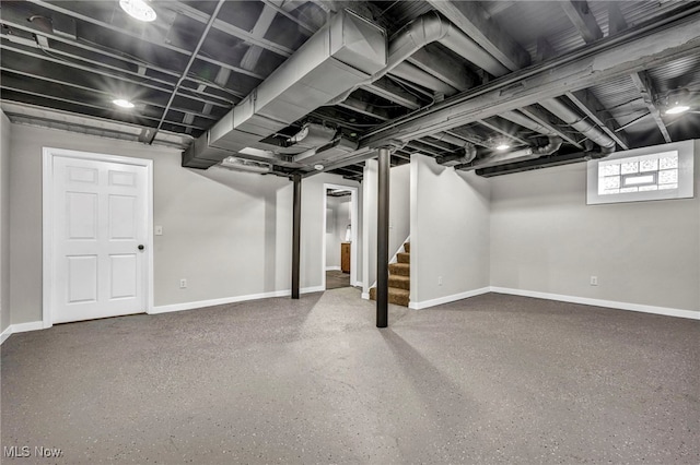 finished basement with stairs and baseboards