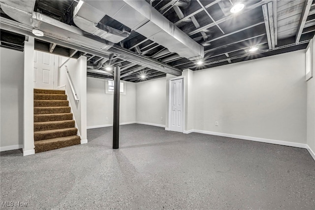 basement with stairway and baseboards