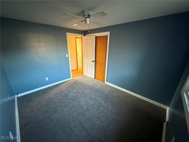 unfurnished bedroom with ceiling fan, carpet flooring, and baseboards