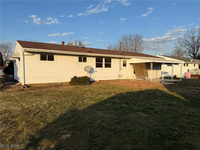 rear view of property with a patio area, cooling unit, and a lawn