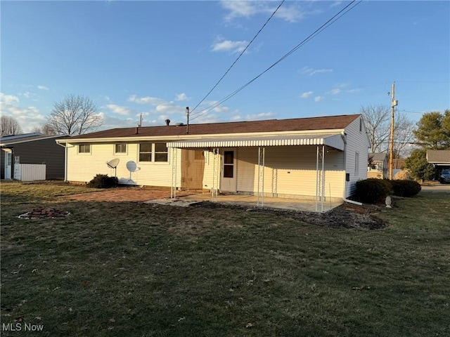 back of property featuring a patio and a yard