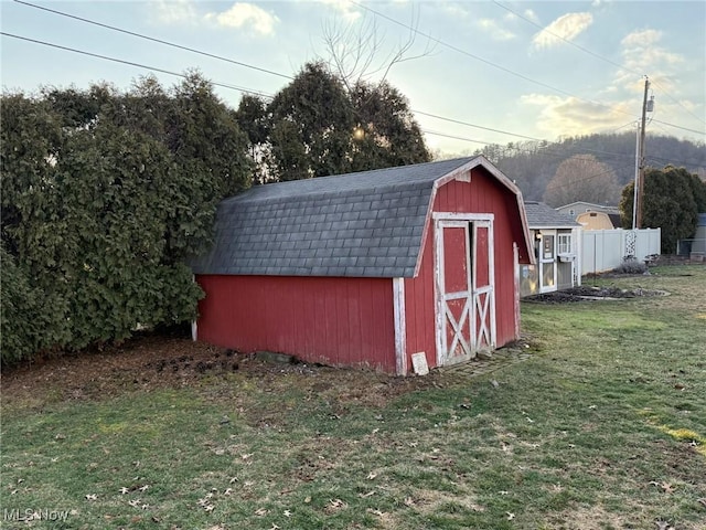 view of shed featuring fence