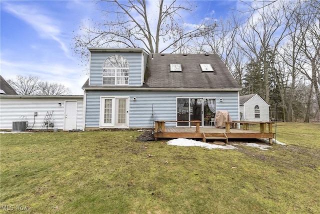 rear view of house with a yard, central AC unit, and a wooden deck