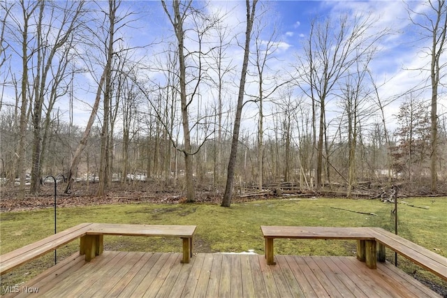 wooden terrace featuring a yard