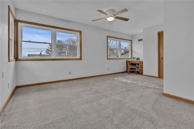 empty room with ceiling fan, carpet floors, and baseboards