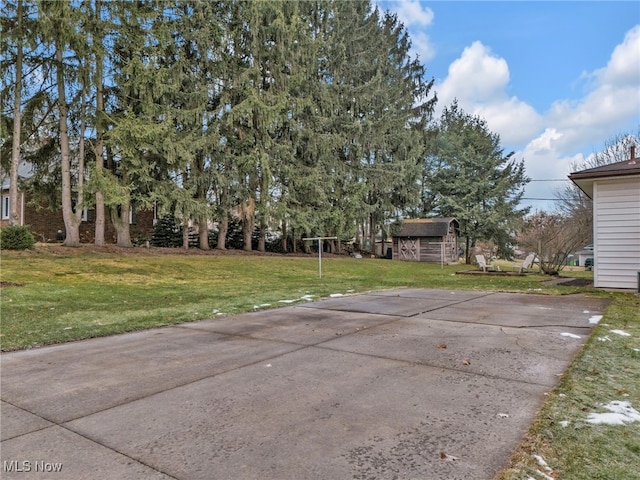 view of patio featuring an outbuilding and a storage unit