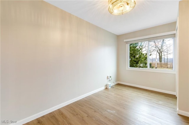 empty room featuring baseboards and wood finished floors