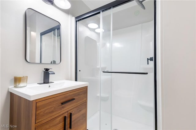 full bathroom with a shower stall and vanity