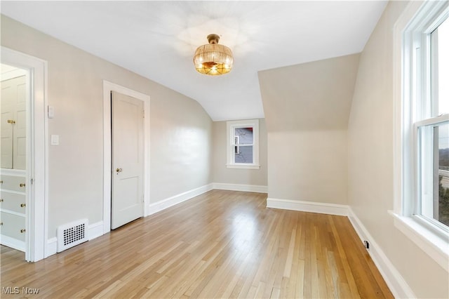 bonus room with a wealth of natural light, light wood-type flooring, visible vents, and baseboards