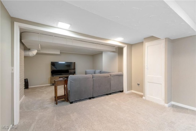 living area featuring light carpet and baseboards