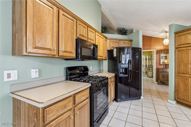 kitchen with light tile patterned floors, lofted ceiling, light countertops, brown cabinets, and black appliances