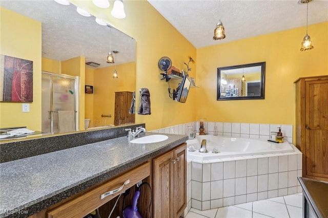 full bathroom featuring a stall shower, tile patterned flooring, a textured ceiling, and vanity