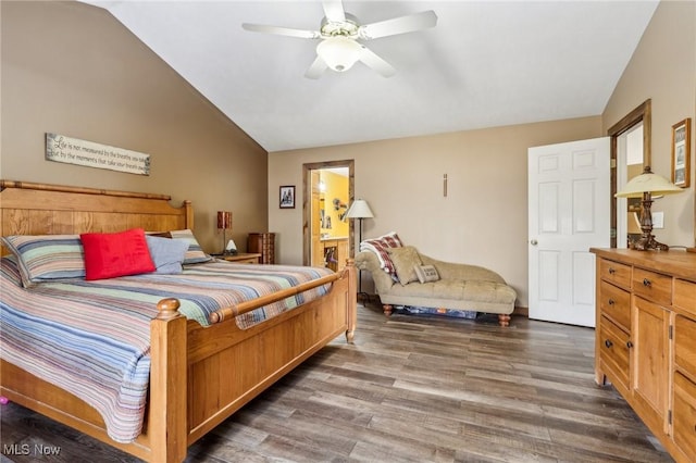 bedroom featuring ceiling fan, vaulted ceiling, and wood finished floors