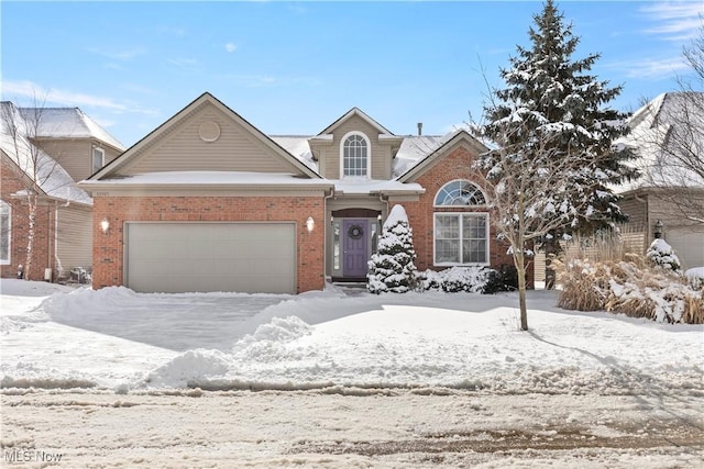 traditional home featuring brick siding and an attached garage