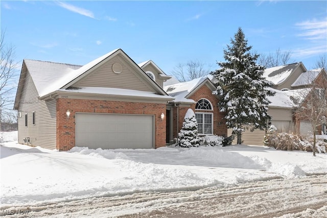 view of front of home featuring an attached garage and brick siding