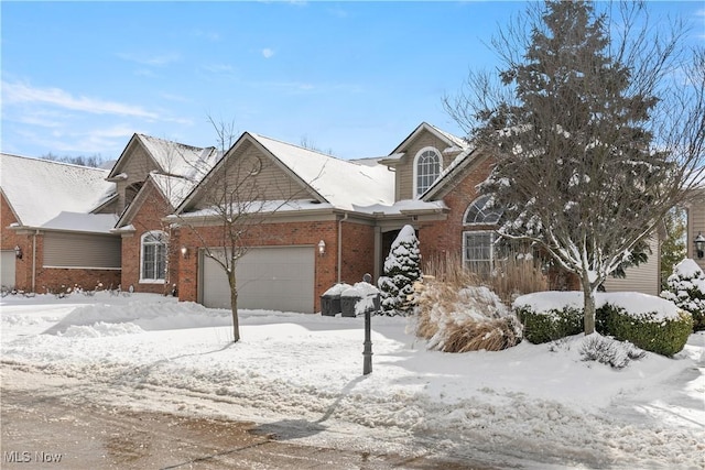 view of front of property featuring brick siding and an attached garage