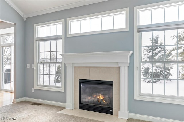 room details featuring crown molding, visible vents, carpet flooring, a tile fireplace, and baseboards