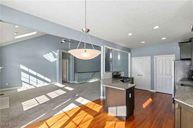 kitchen featuring baseboards, appliances with stainless steel finishes, a peninsula, light stone countertops, and recessed lighting