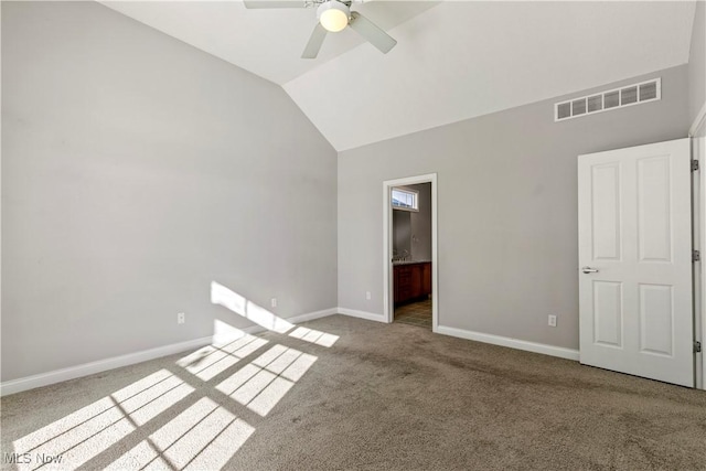 unfurnished bedroom featuring ensuite bathroom, carpet floors, visible vents, baseboards, and vaulted ceiling