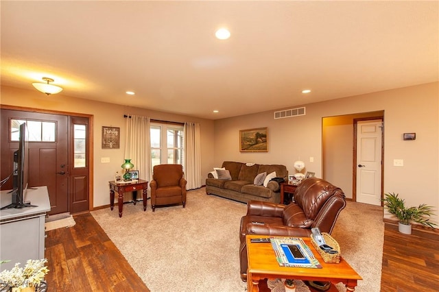 living area with baseboards, visible vents, dark wood-style flooring, and recessed lighting