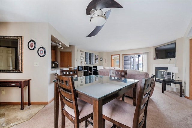 225 N Bayshore Dr Unit 3, Columbiana, OH 44408 - dining area featuring light carpet, ceiling fan, and a glass covered fireplace