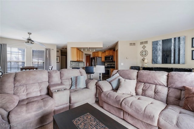 living room with rail lighting and visible vents