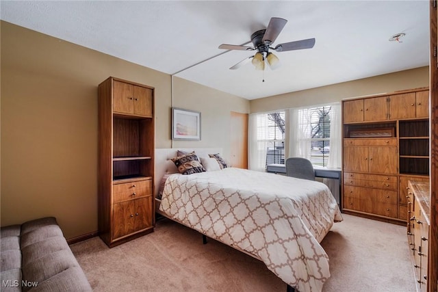bedroom with a ceiling fan and light colored carpet