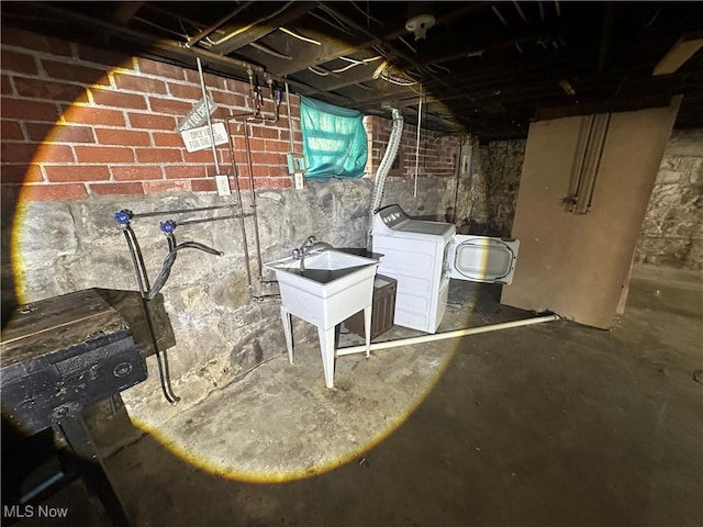 basement with a sink and washer / dryer