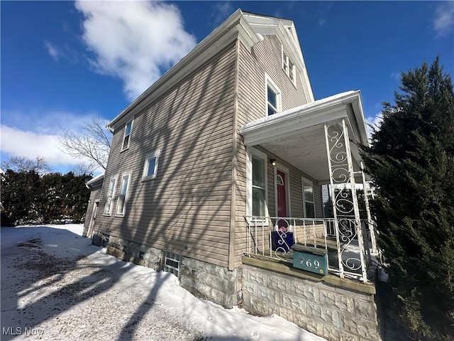 view of side of property with a porch