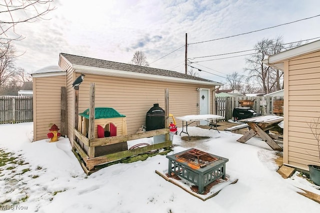 exterior space with fence and a fire pit