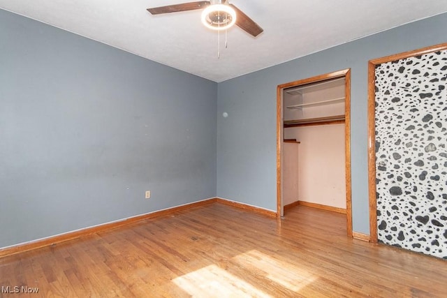 unfurnished bedroom featuring light wood-type flooring, a ceiling fan, and baseboards