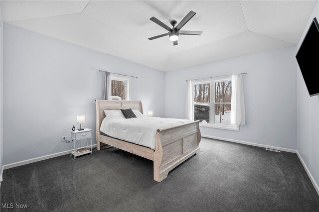 10565 Valley View Rd, Sagamore Hills, OH 44067 - bedroom featuring multiple windows, vaulted ceiling, baseboards, dark colored carpet, and ceiling fan
