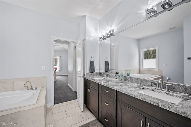 10565 Valley View Rd, Sagamore Hills, OH 44067 - bathroom featuring double vanity, a bath, tile patterned floors, and baseboards