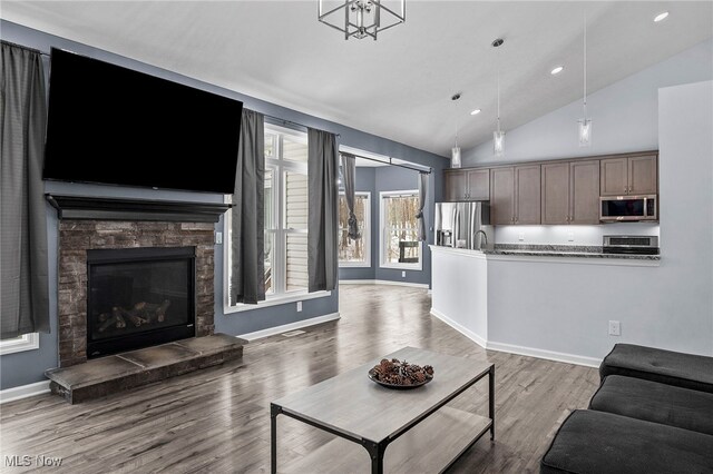 10565 Valley View Rd, Sagamore Hills, OH 44067 - living area with lofted ceiling, wood finished floors, recessed lighting, a fireplace, and baseboards