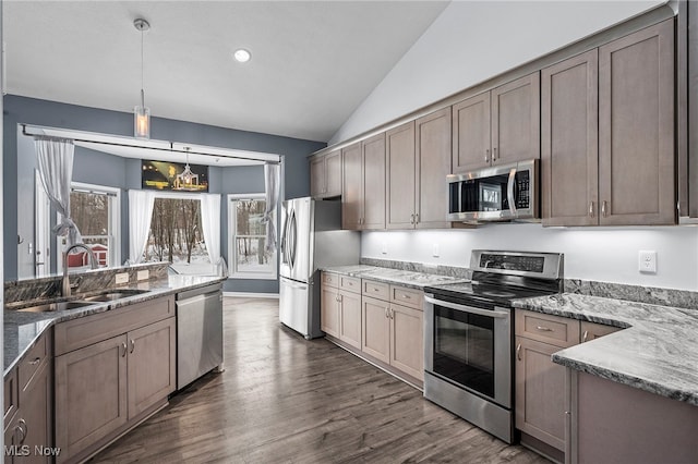10565 Valley View Rd, Sagamore Hills, OH 44067 - kitchen with appliances with stainless steel finishes, a sink, vaulted ceiling, dark wood finished floors, and light stone counters