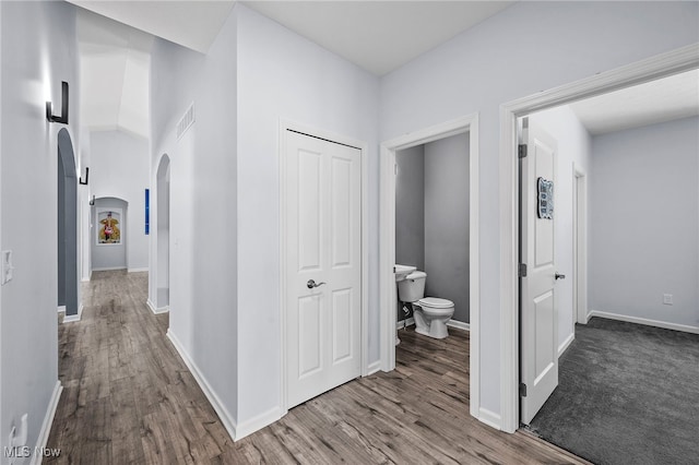 10565 Valley View Rd, Sagamore Hills, OH 44067 - hall featuring arched walkways, wood finished floors, and baseboards
