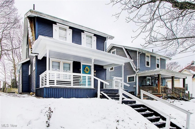 view of front of property with covered porch and stairs