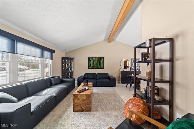 tiled living room with lofted ceiling with beams and a textured ceiling