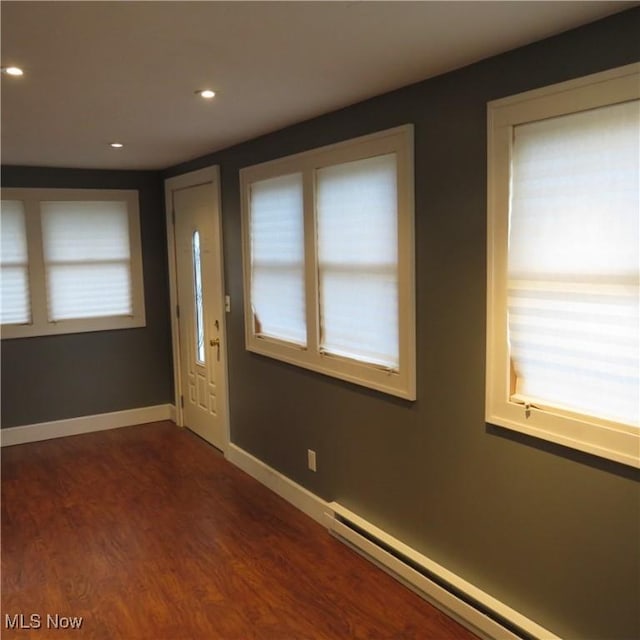 foyer with a baseboard heating unit, recessed lighting, dark wood-style floors, and baseboards