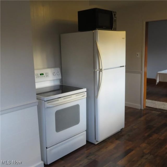 kitchen featuring dark wood-style floors and white appliances