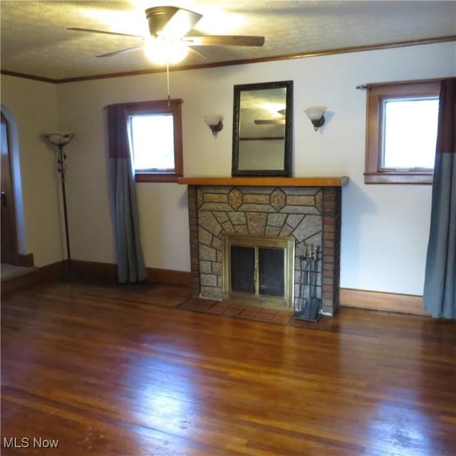 unfurnished living room with a fireplace with flush hearth, crown molding, and wood finished floors