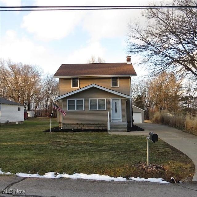 view of front of house with a chimney, entry steps, a front yard, a garage, and an outdoor structure