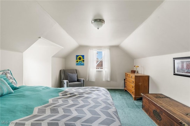 bedroom with lofted ceiling and carpet