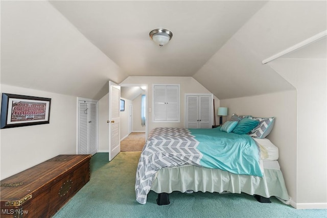 bedroom with lofted ceiling, carpet, and baseboards